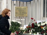 Москвичи несут цветы к посольству Франции.